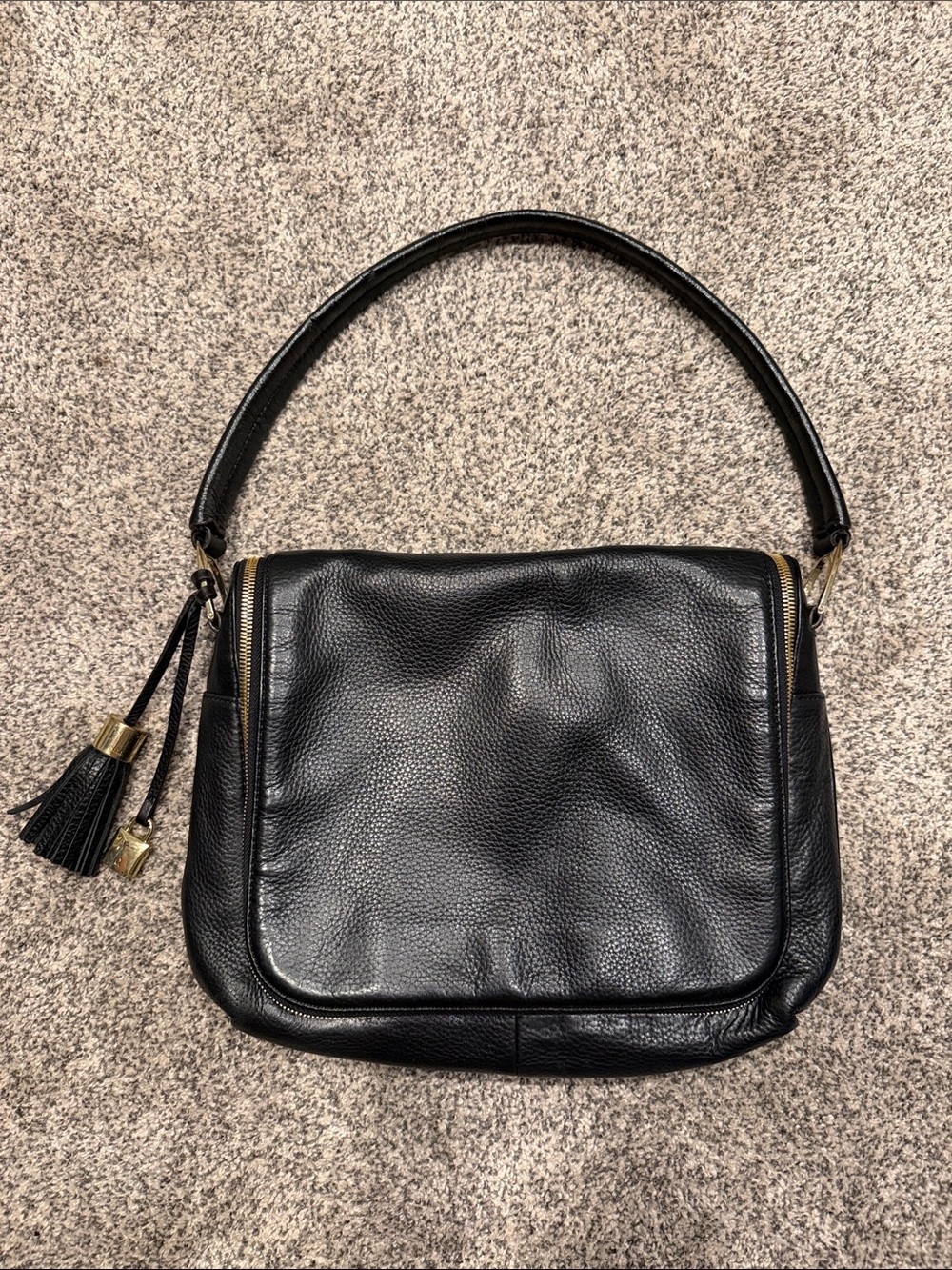 Elegant Black Leather Shoulder Bag with Tassel Detail